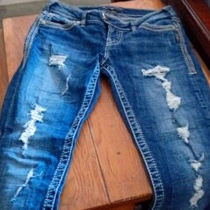 Silver distresses Tuesday skinny jeans.